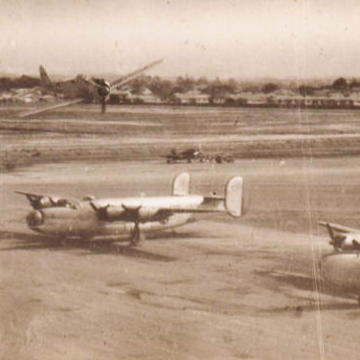 Test flight of a Japanese Oscar fighter over B-24 Liberators at Eagle Farm airfield
